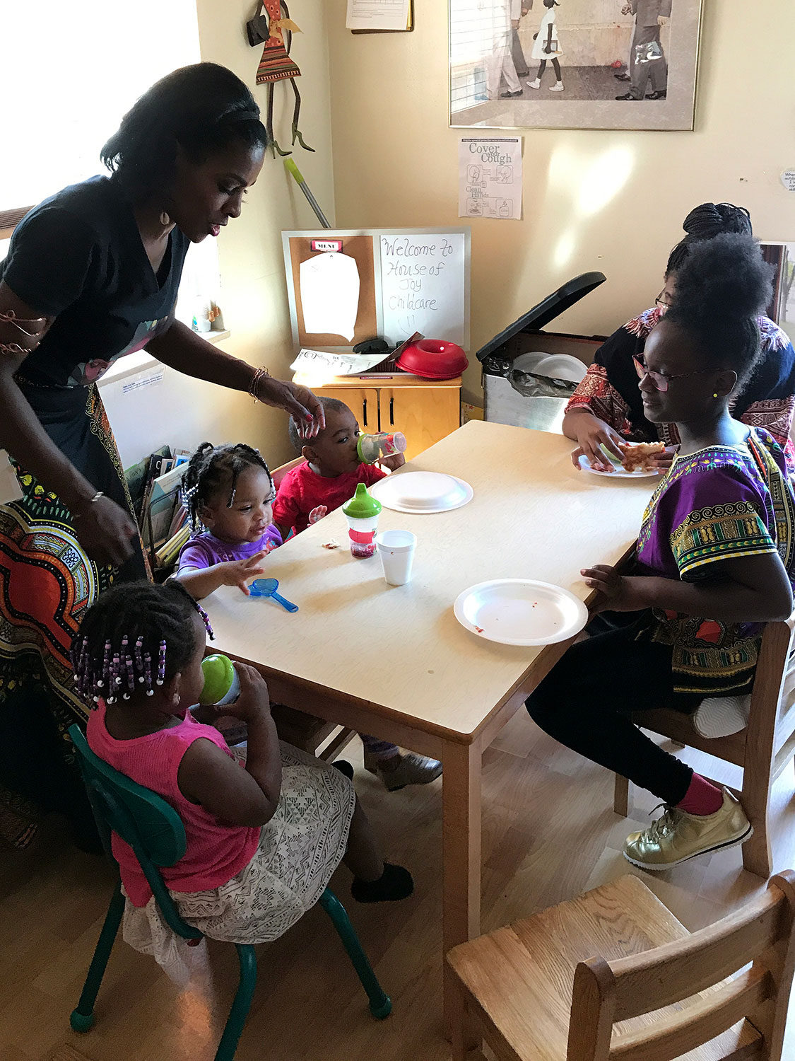 Lorna Parks serves lunch at her home-based child care program, called House of Joy, in Detroit. Most home child care programs include a midday meal, usually prepared by the owner.